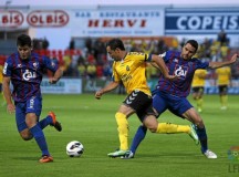 Tato trata de zafarse de dos defensores del Huesca / LFP