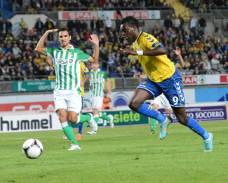 Chrisantus persigue el esférico ante la presencia del grancanario Ángel López, en el partido de ida / Samuel Sánchez (udlaspalmas.net)