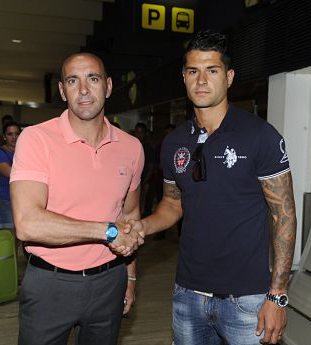 Monchi estrecha la mano con Vitolo, este lunes en el Aeropuerto de Sevilla / El Desmarque de Sevilla