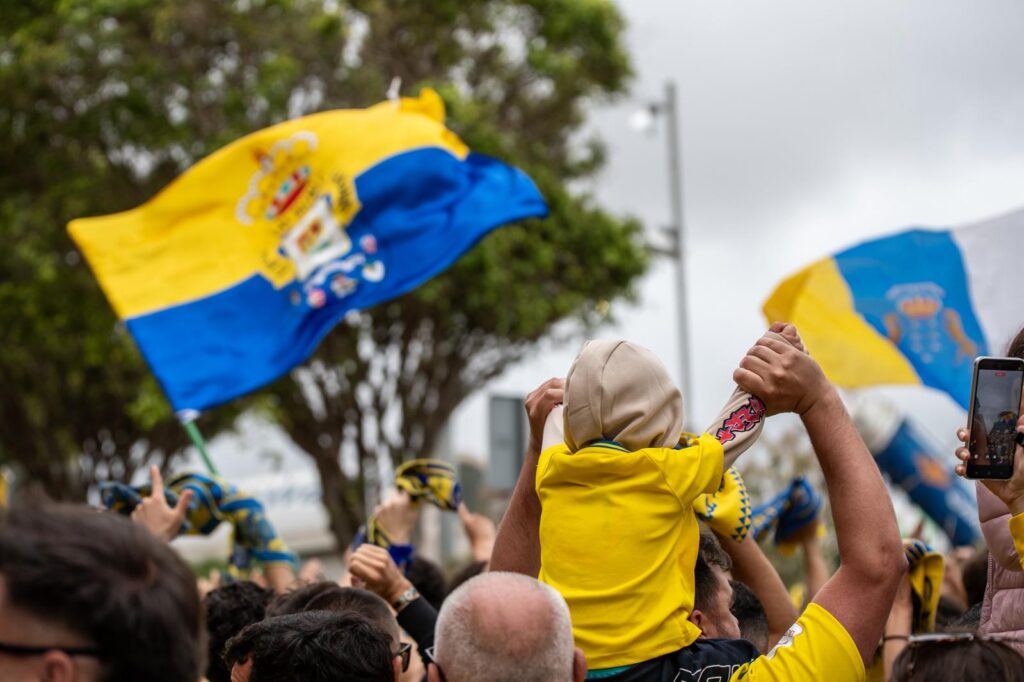 WhatsApp Image 2026-06-07 at 183226 1 | udlaspalmas.NET FOTOS | Vea la fotogalería del espectacular recibimiento en Fondos de Segura, previo al encuentro ante el Málaga. Una vez más la afición amarillo no defraudó. A las 18:00 horas la marea amarilla se citó en la calle Fondos de Segura, como en los grandes días. Allí los jugadores recibieron el aliento y energía de